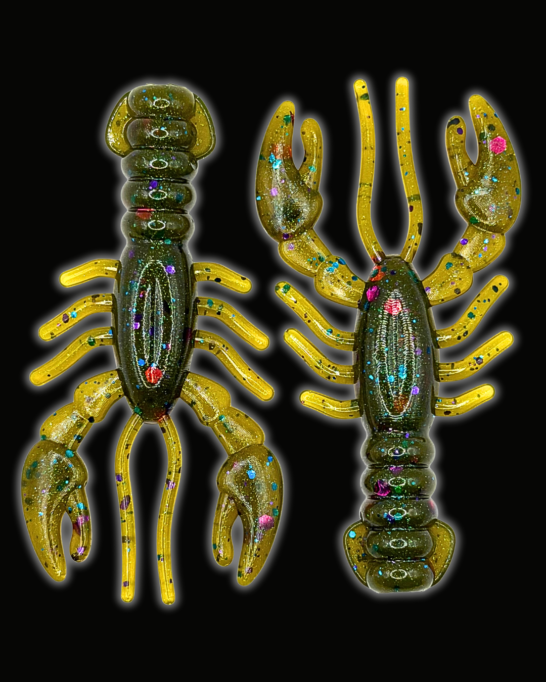 Two lobster-shaped fishing lures shown on a black background, one facing left and one facing right. They have a translucent yellow body with glittery green and blue iridescent accents and small multicolored rhinestone-like details.
