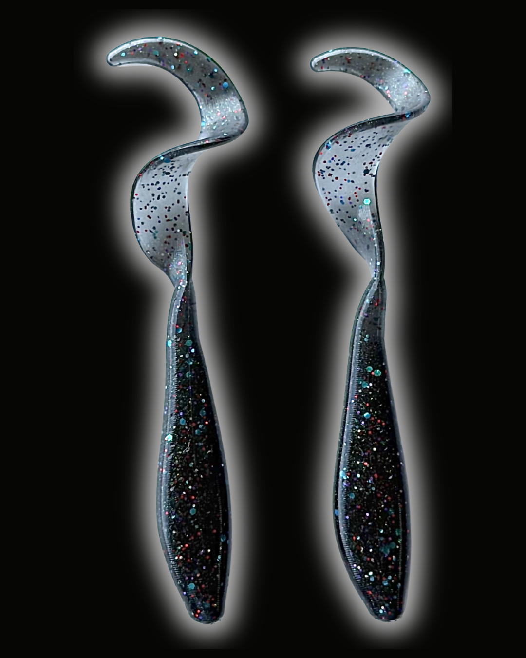 Two Okie Angler Co 3.5" Okie Twisters in Space Candy - a compact paddle-tail swimbait on a black background.