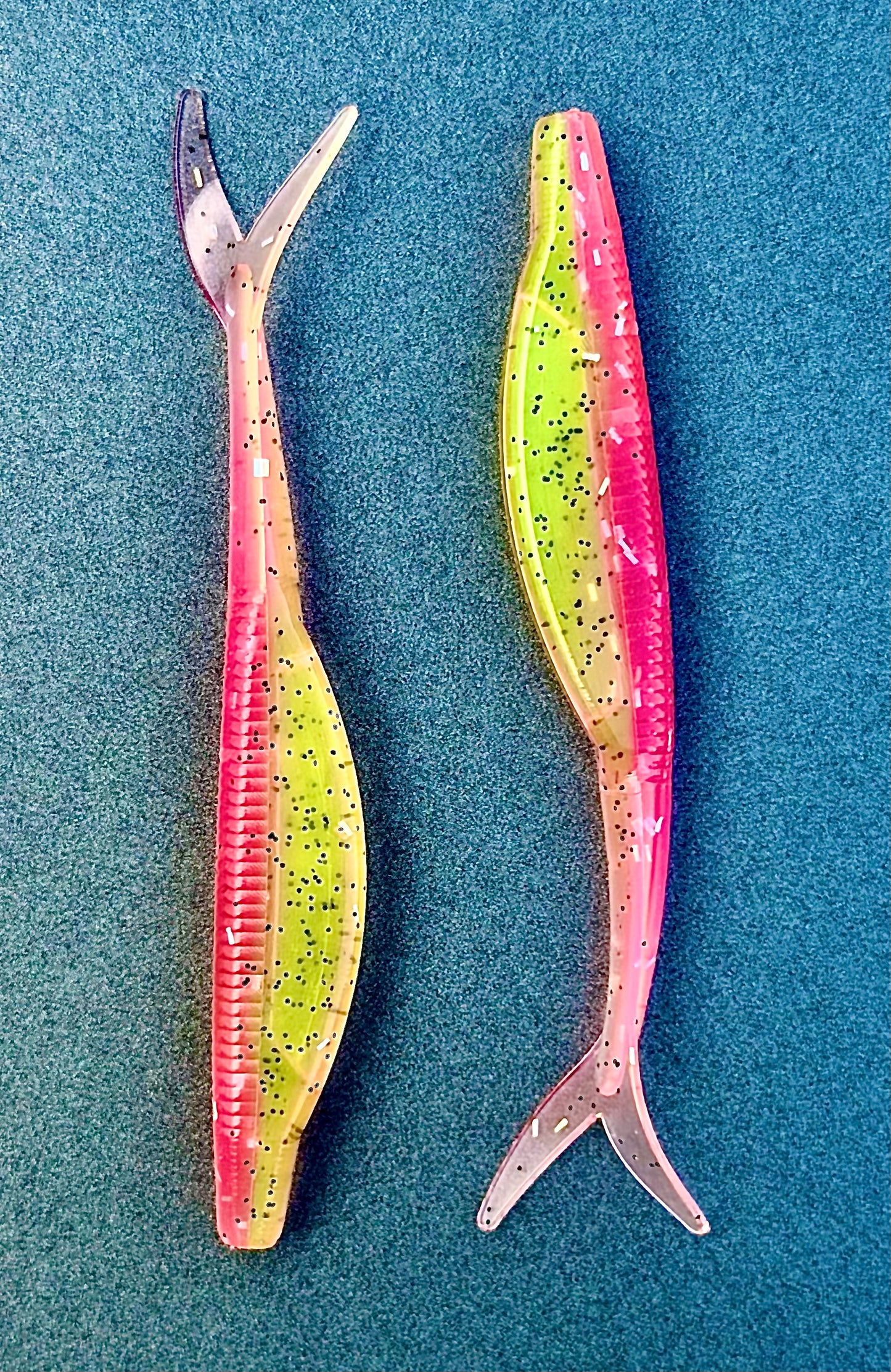 Two colorful fishing lures on a blue background