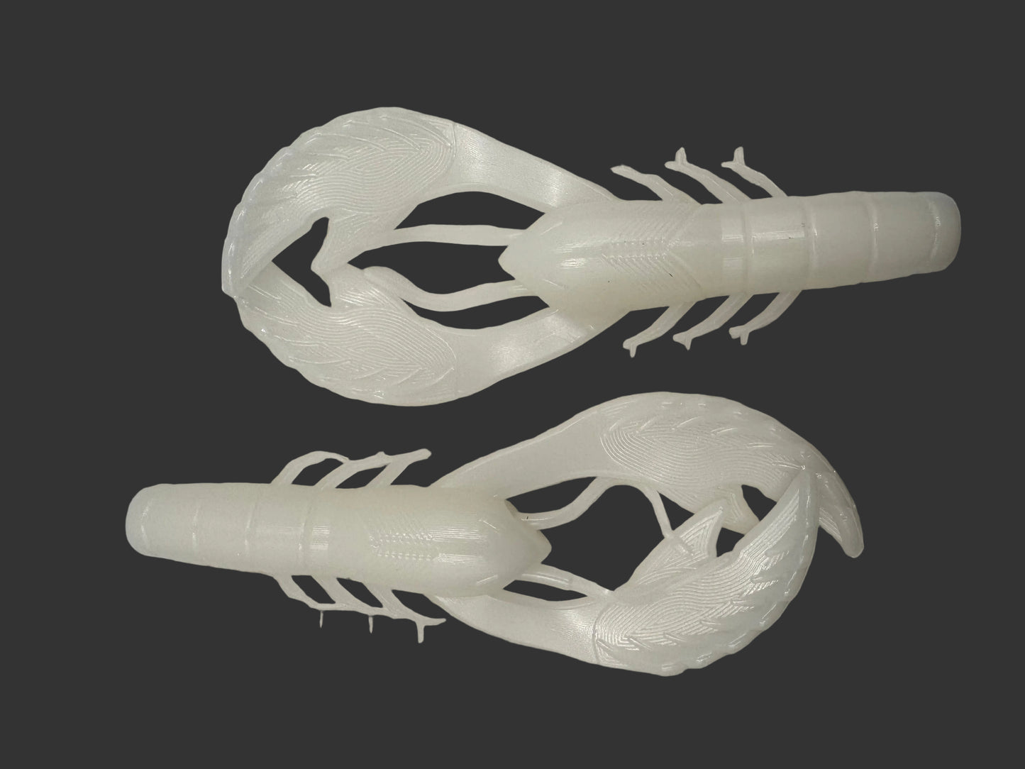 Two Okie Angler Co 4" Okie Craws in the color Pearl White - crawfish-style bass fishing lures on a black background.