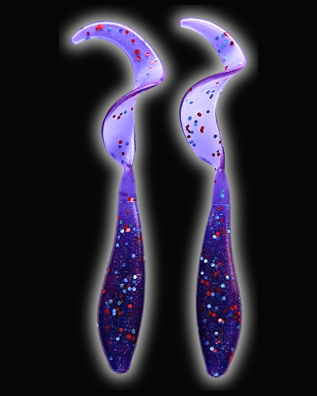 Two Okie Angler Co 3.5" Okie Twisters in Okie Red - a compact paddle-tail swimbait on a black background.