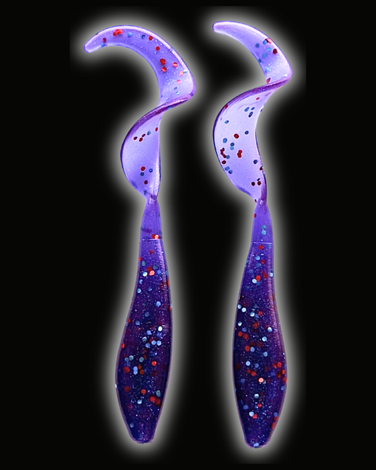 Two Okie Angler Co 3.5" Okie Twisters in Okie Red - a compact paddle-tail swimbait on a black background.