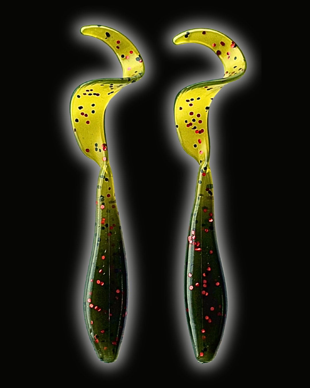 Two Okie Angler Co 3.5" Okie Twisters in Watermelon Red - a compact paddle-tail swimbait on a black background.