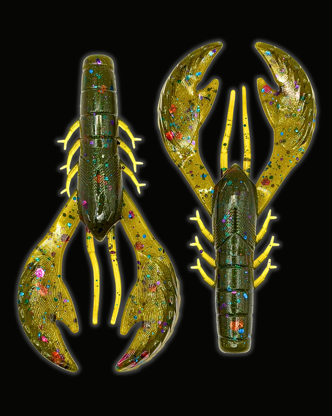 Two lobster-shaped fishing lures against a solid black background. The lures feature a metallic gold base with iridescent, multicolored rhinestone-like glitter and a bright yellow-gold outline.