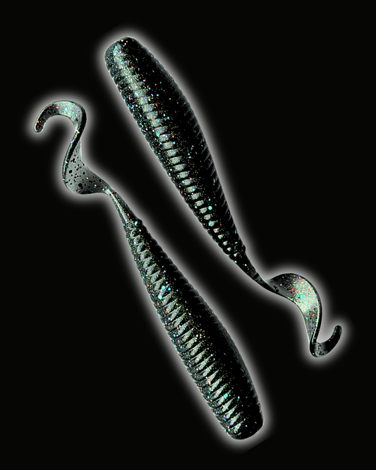 Okie Angler Co Space Candy 5" Okie Stud ribbed curl-tail soft plastic fishing lures on a black background.