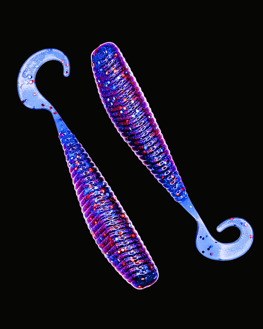 Okie Angler Co Okie Red 5" Okie Stud ribbed curl-tail soft plastic fishing lures on a black background.