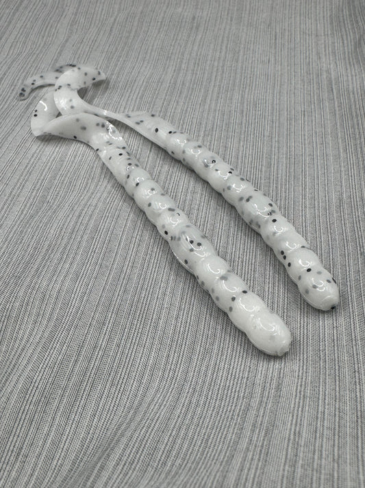 Okie Angler Co 10" Salt and Pepper Curl Tail Worms for bass fishing on a grey and white striped background. 
