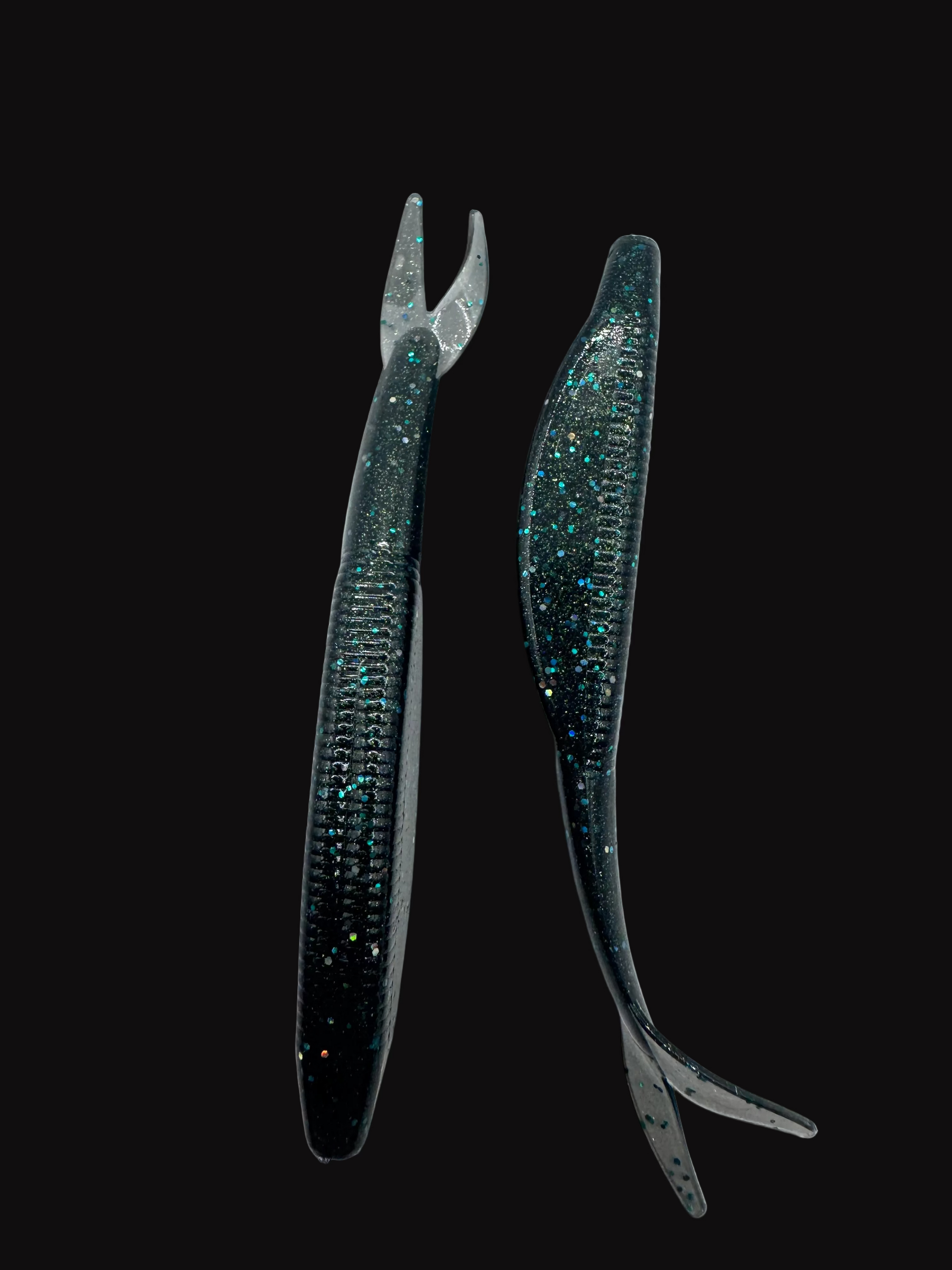 Two black fishing lures with glittery accents on a white background