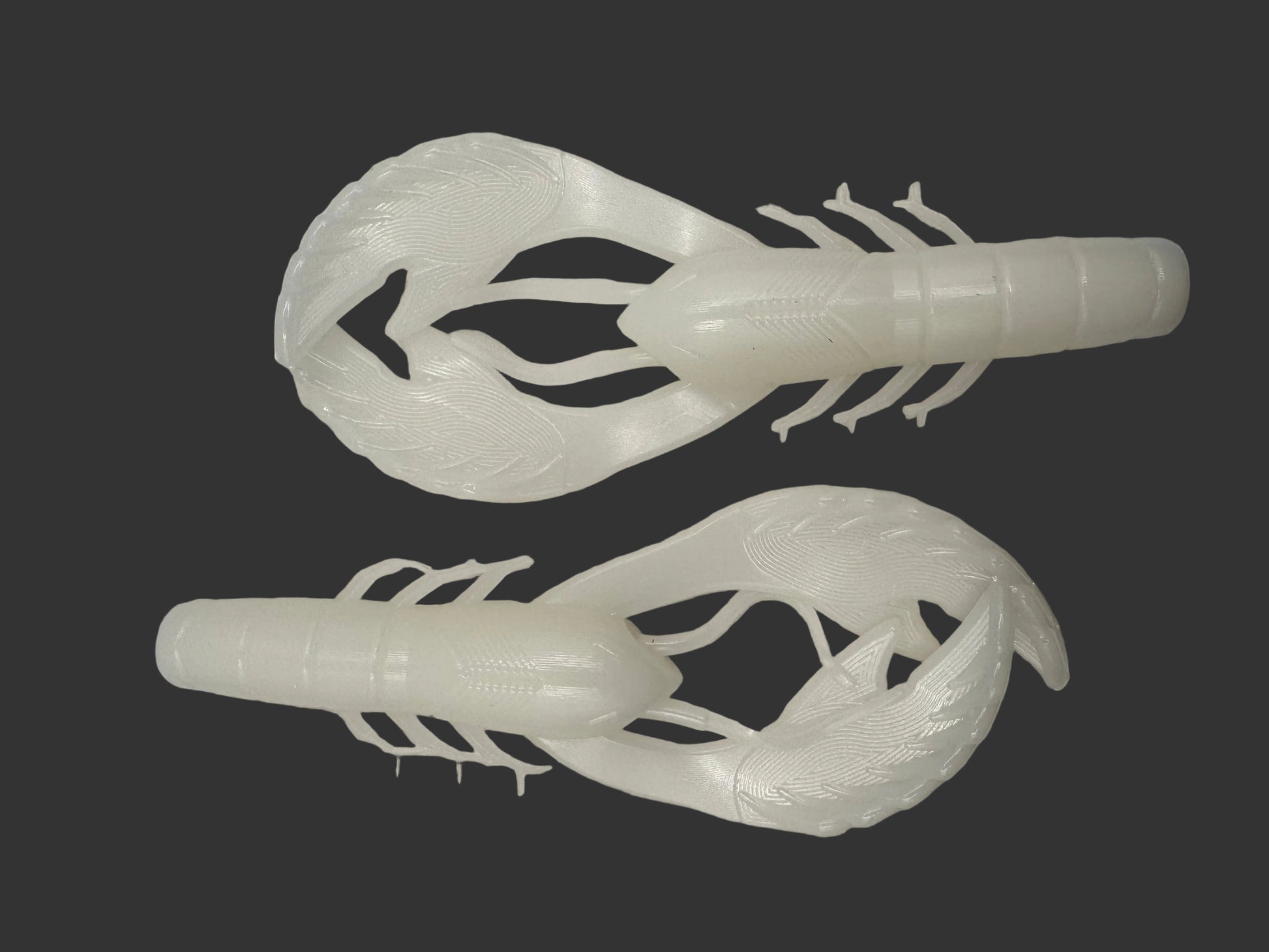 Two Okie Angler Co 4" Okie Craws in the color Pearl White - crawfish-style bass fishing lures on a black background.